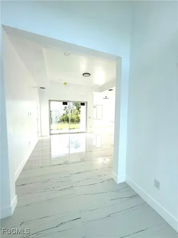 a large kitchen with stainless steel appliances kitchen island granite countertop a refrigerator and a sink