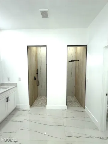 a bathroom with a granite countertop toilet and a sink