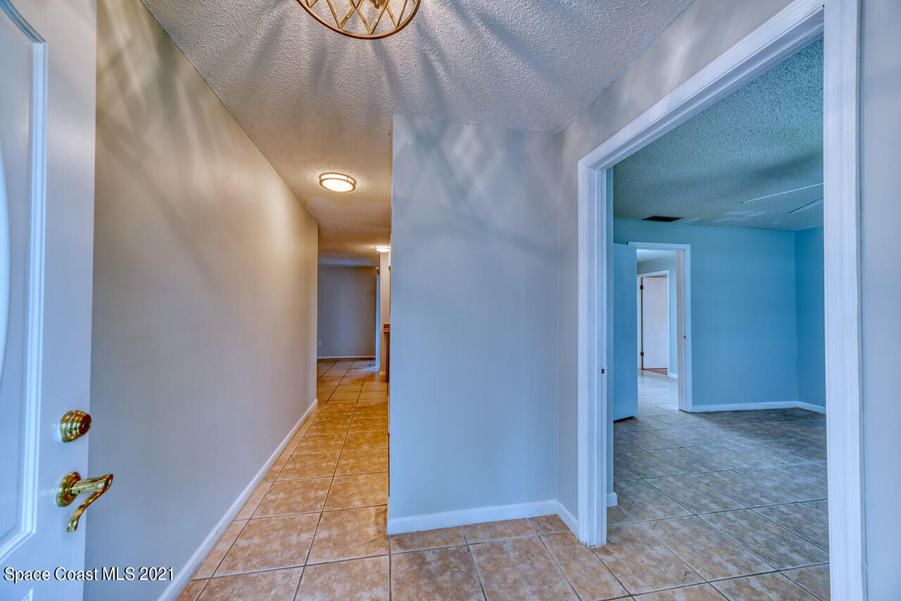 553 Edward Road West Melbourne, FL 32904 - Photo 11 of 26 a view of a hallway with wooden floor