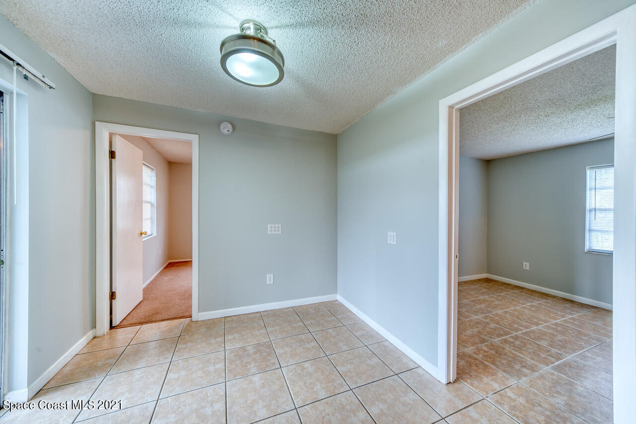 553 Edward Road West Melbourne, FL 32904 - Photo 15 of 26 a view of a hallway with wooden floor and a livingroom view