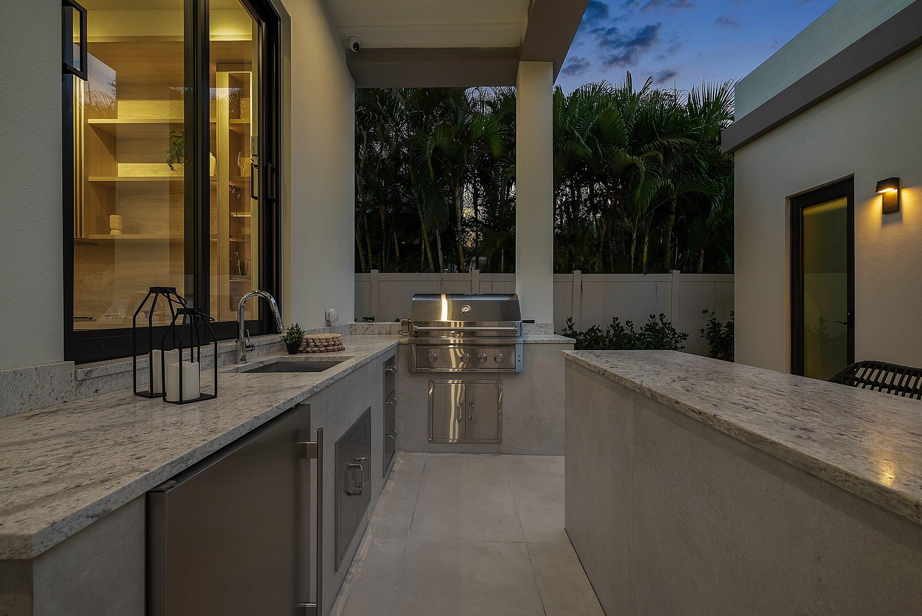 299 Northeast 7th Street Boca Raton, FL 33432 - Photo 106 of 112 a kitchen with stainless steel appliances granite countertop a sink and a large window
