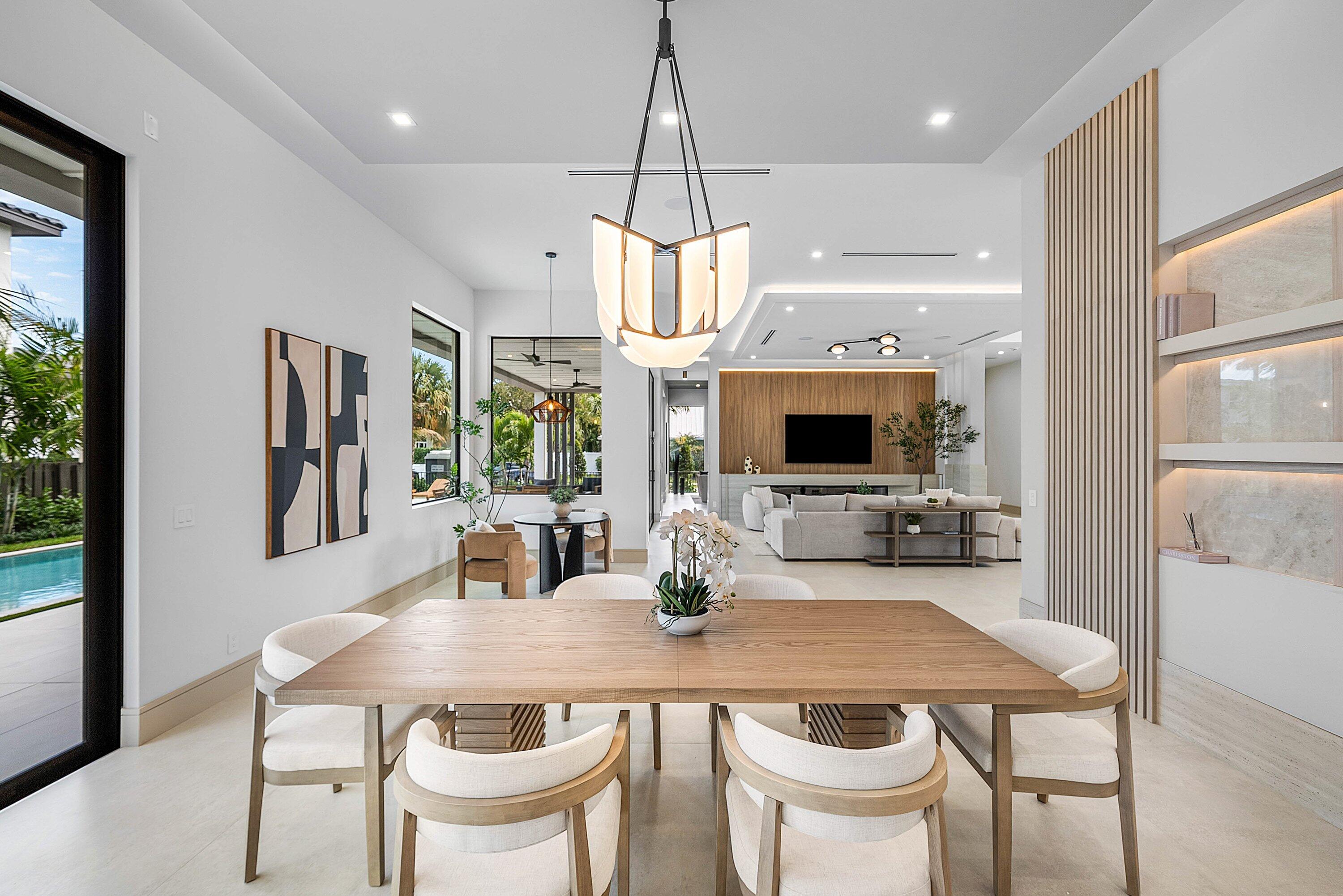299 Northeast 7th Street Boca Raton, FL 33432 - Photo 16 of 112 a dining room with wooden floor a chandelier a wooden table and chairs