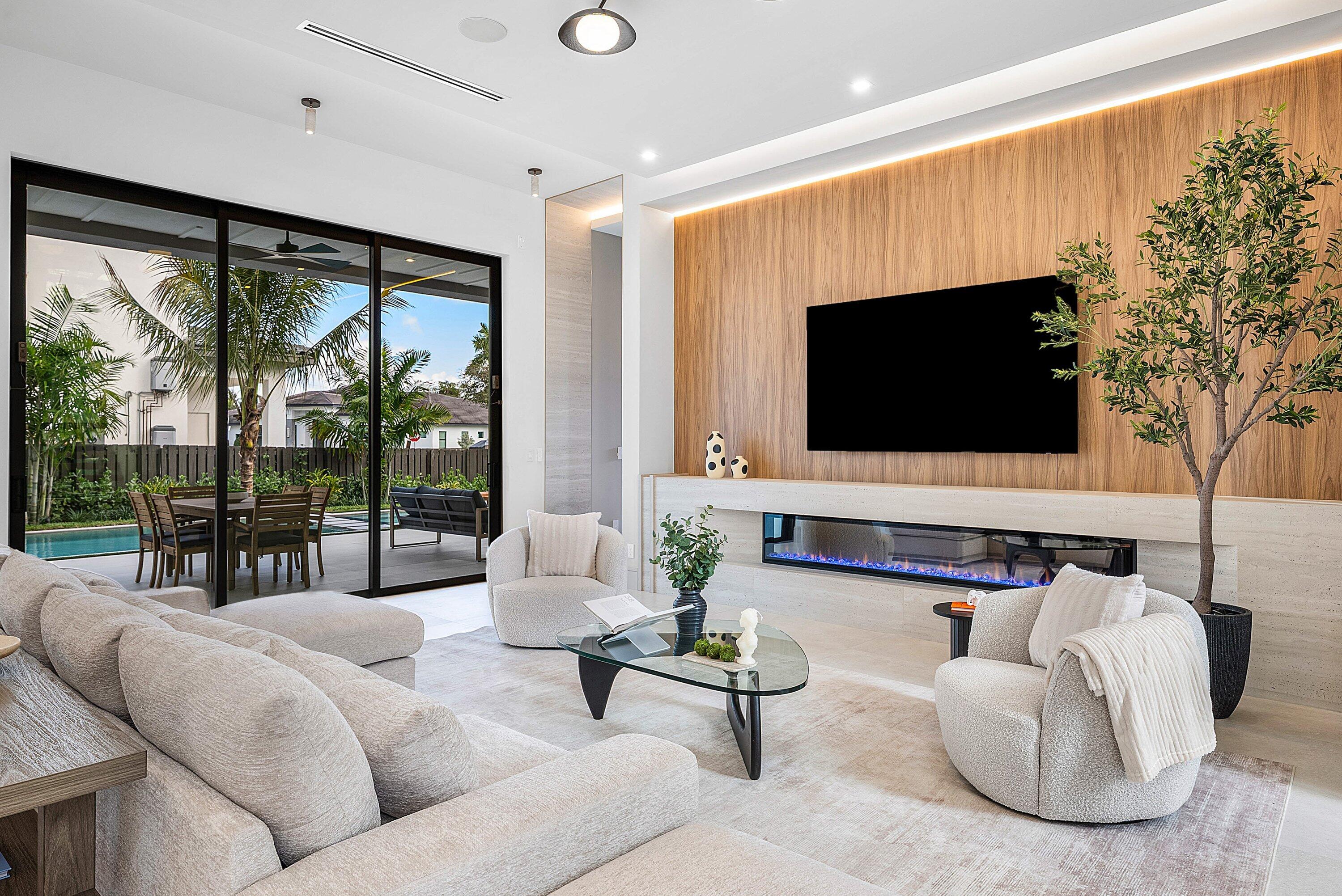 299 Northeast 7th Street Boca Raton, FL 33432 - Photo 24 of 112 a living room with furniture a flat screen tv and a floor to ceiling window