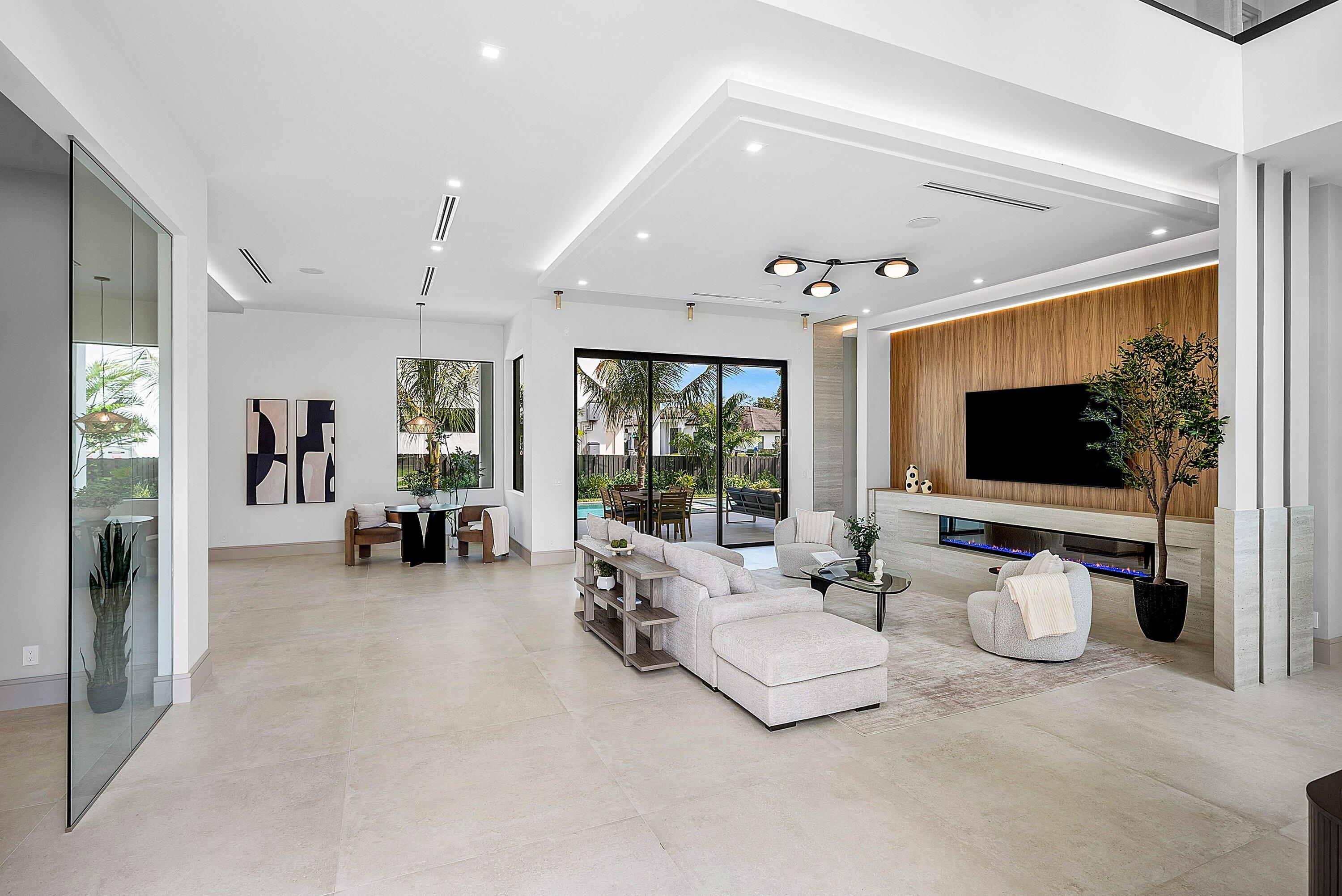 299 Northeast 7th Street Boca Raton, FL 33432 - Photo 28 of 112 a living room with furniture and a flat screen tv
