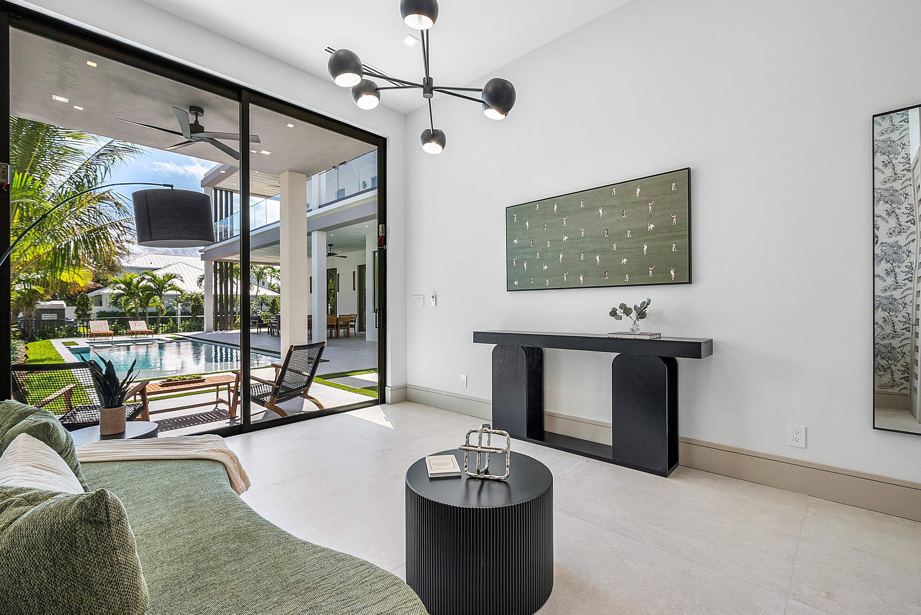299 Northeast 7th Street Boca Raton, FL 33432 - Photo 32 of 112 a living room with furniture and a flat screen tv