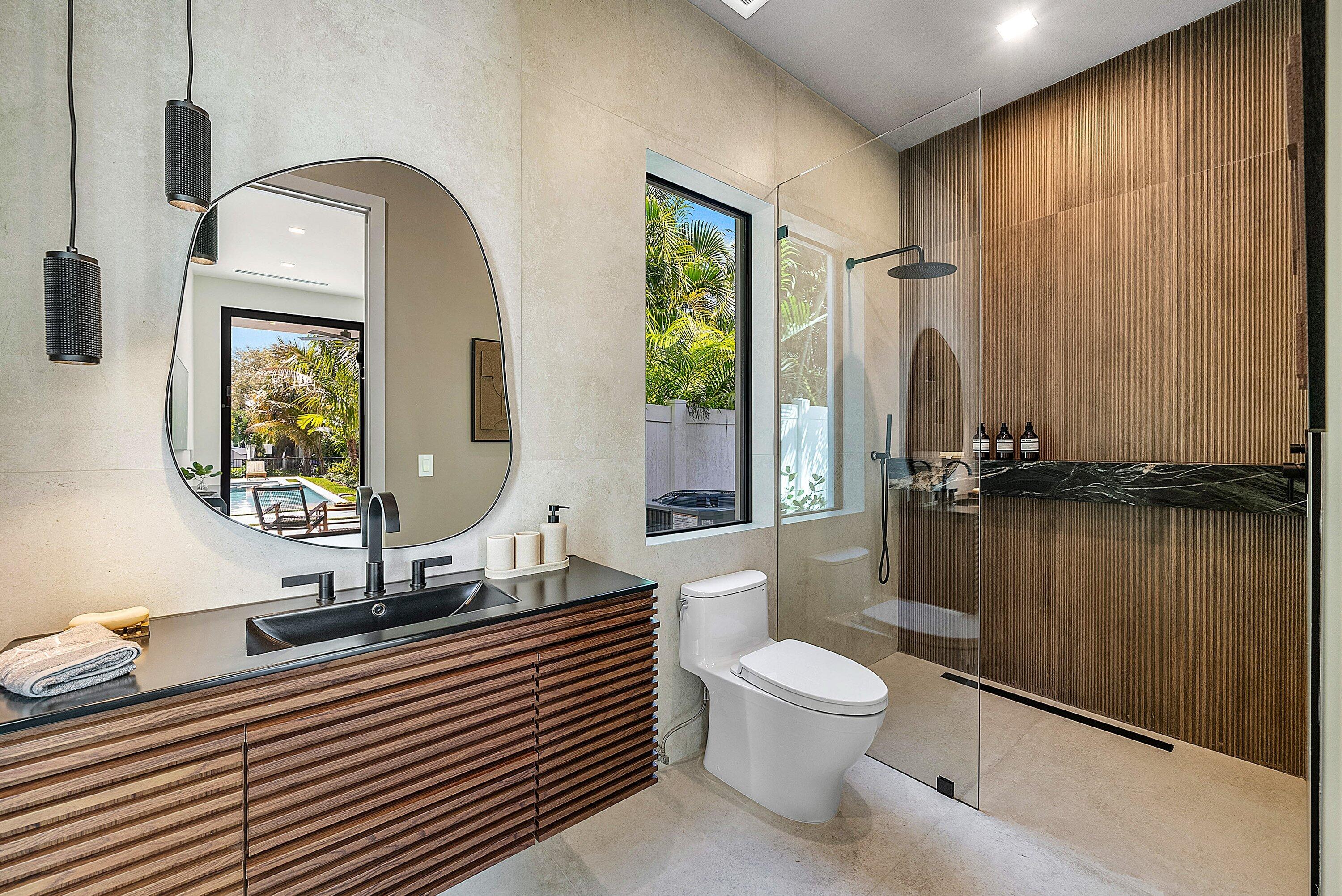 299 Northeast 7th Street Boca Raton, FL 33432 - Photo 33 of 112 a bathroom with a toilet a sink and mirror