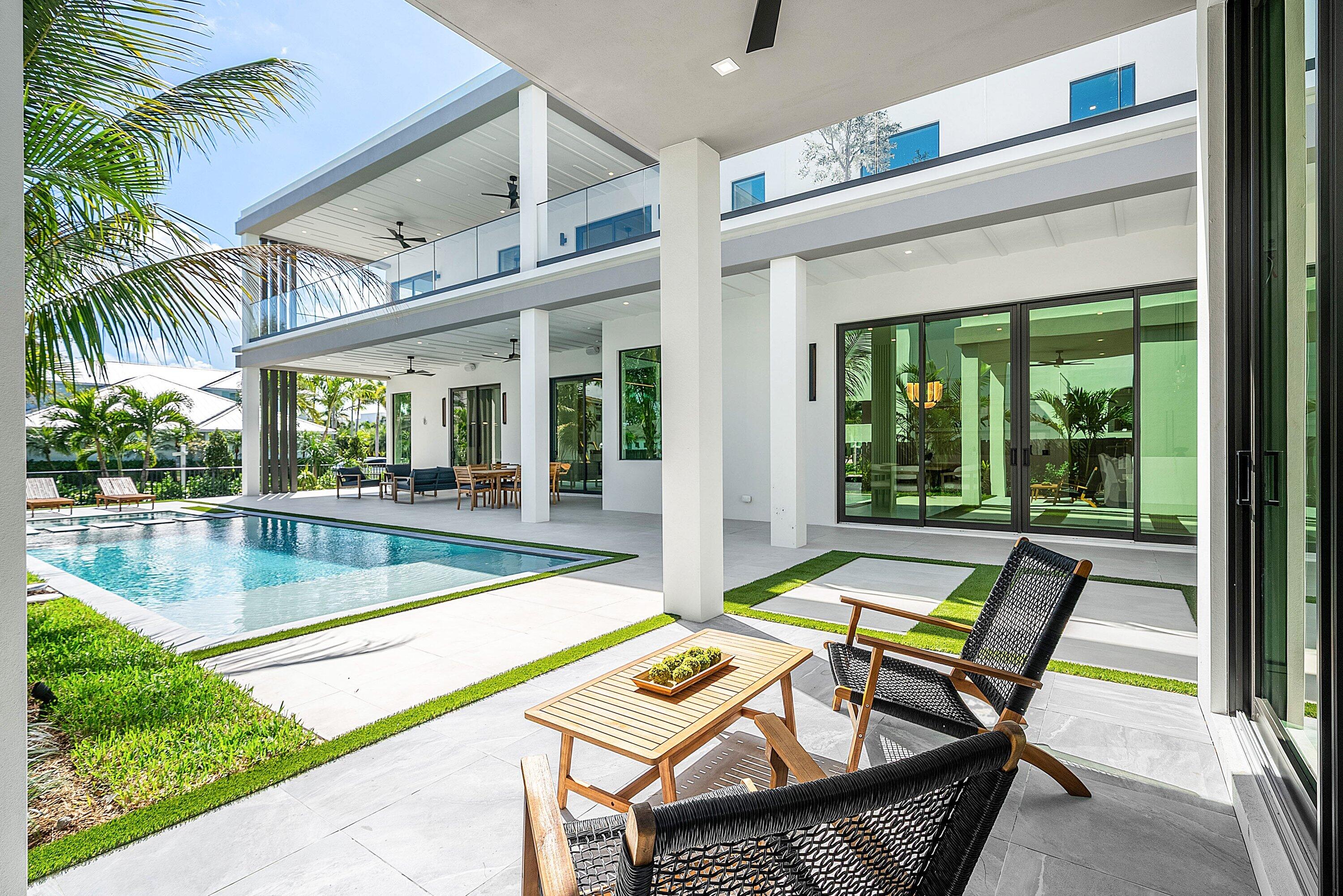 299 Northeast 7th Street Boca Raton, FL 33432 - Photo 78 of 112 a view of a patio with swimming pool table and chairs