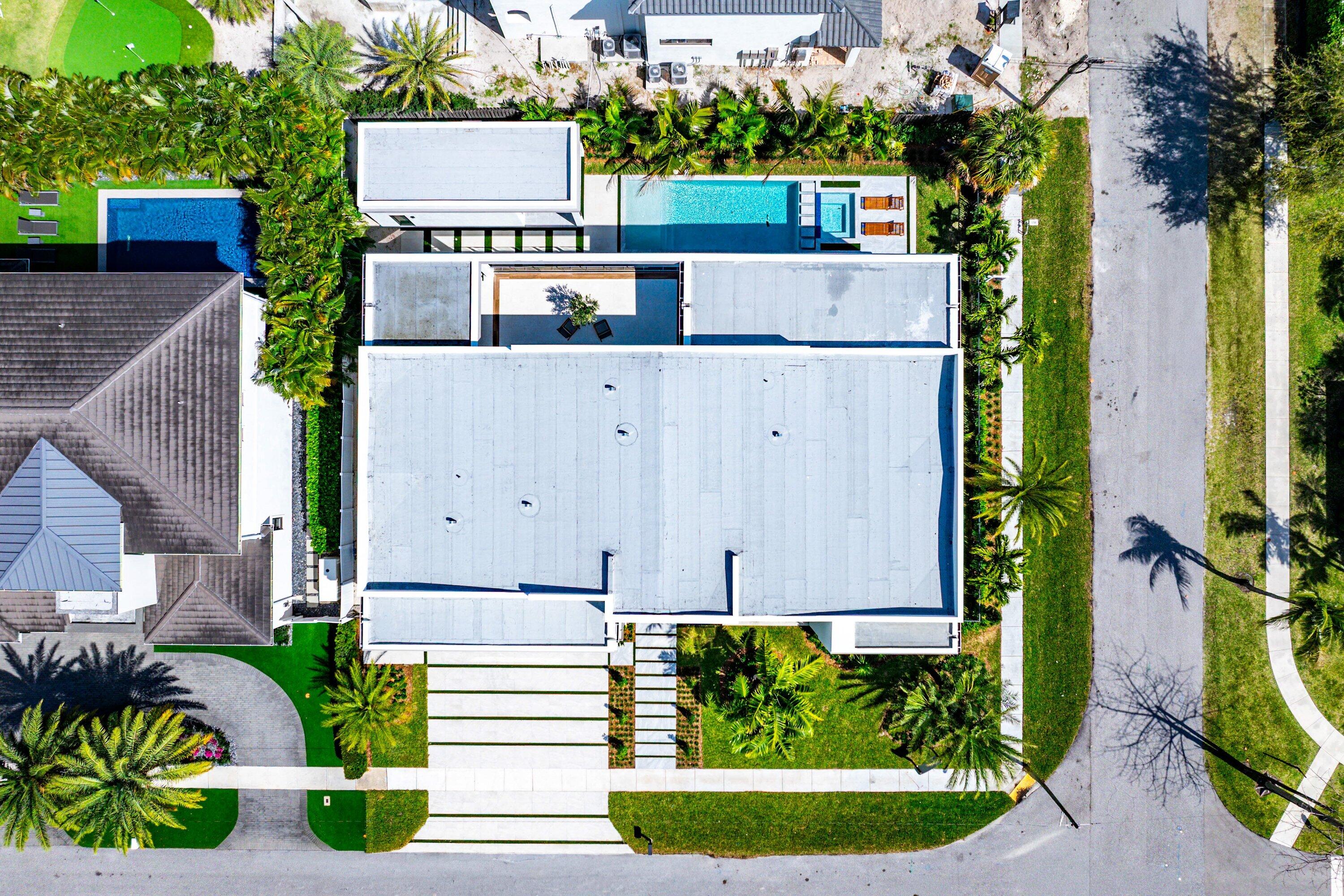 299 Northeast 7th Street Boca Raton, FL 33432 - Photo 83 of 112 a view of a house with a street sign and a flower garden