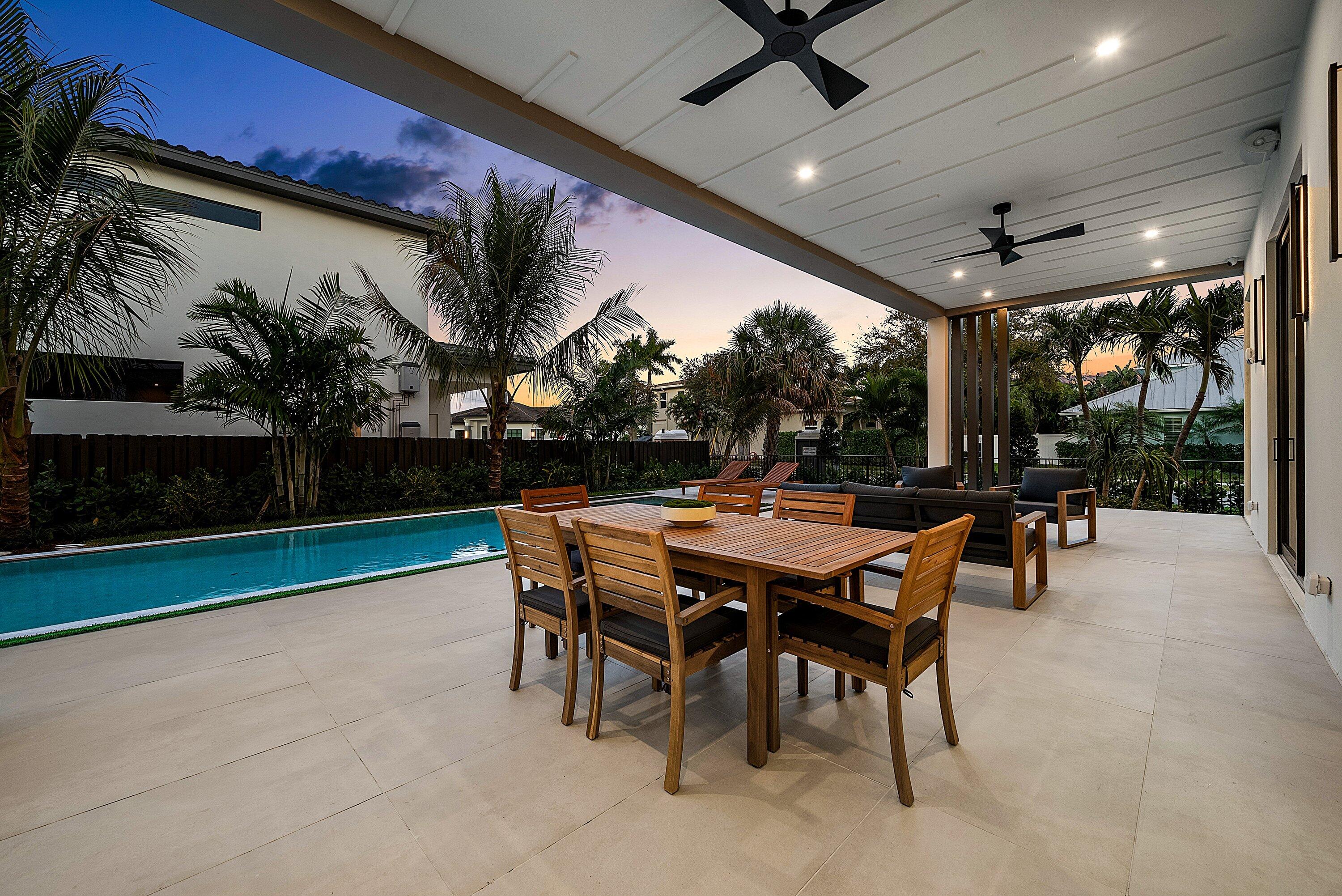 299 Northeast 7th Street Boca Raton, FL 33432 - Photo 100 of 112 a dining room with furniture and a garden