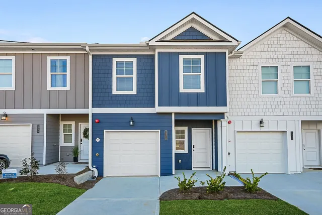 a front view of a house with garden