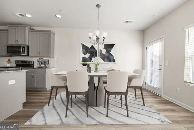 a view of a dining room with furniture and wooden floor
