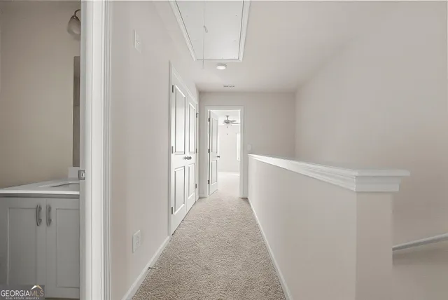a view of a hallway with white walls