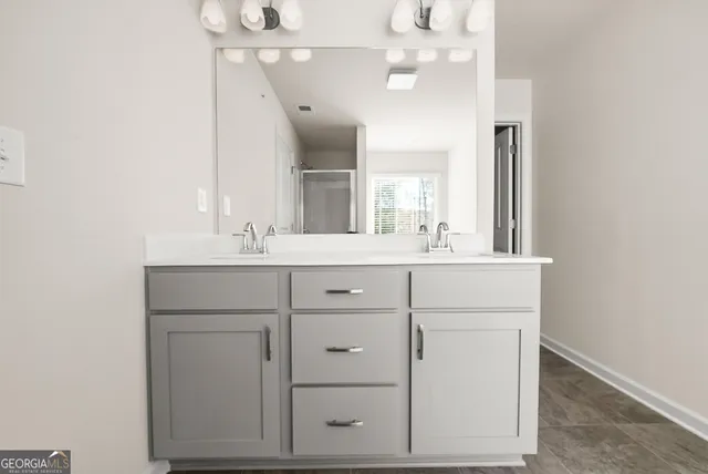a bathroom with a sink vanity and a mirror