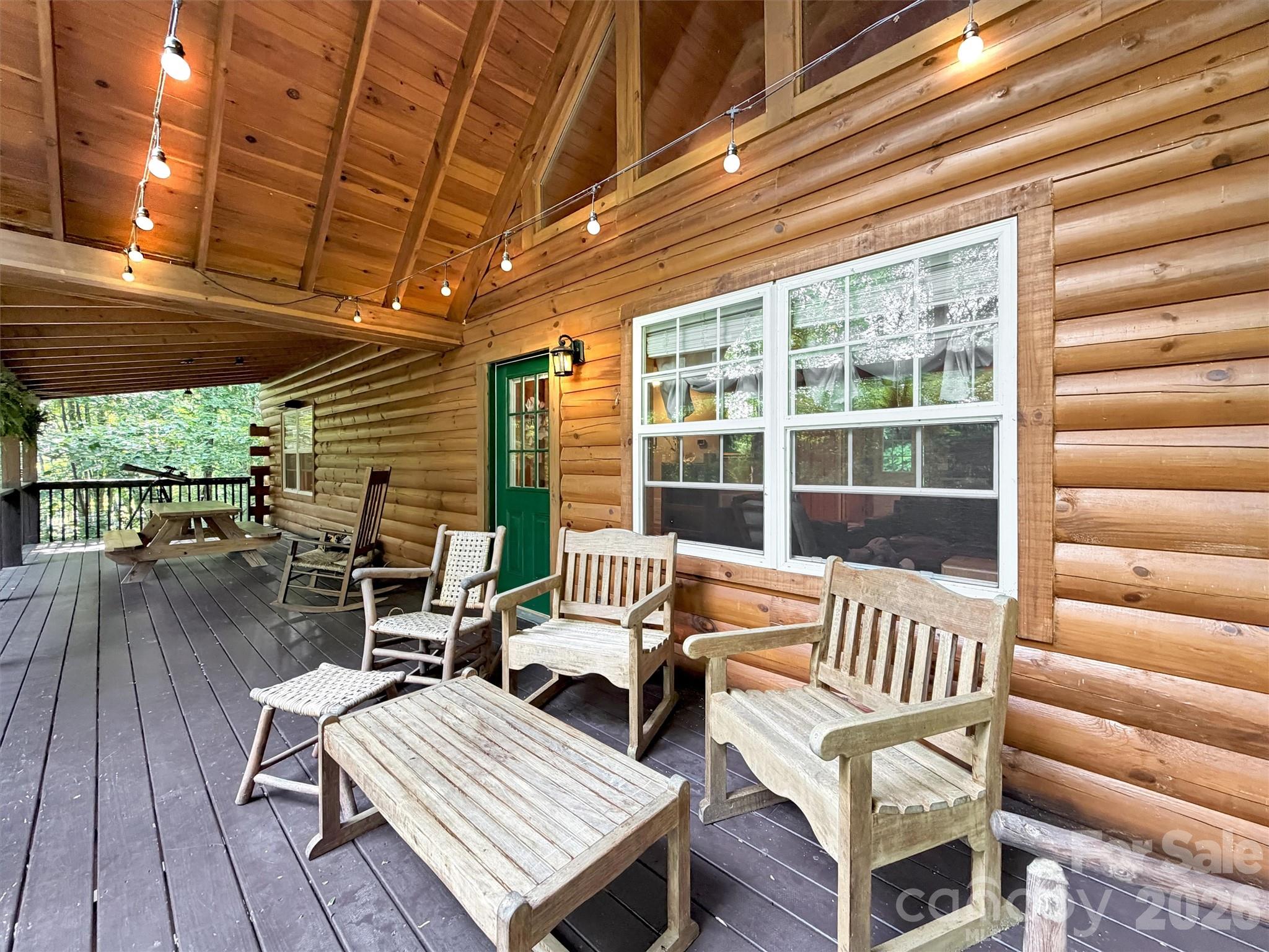 49 Brandywine Road Waynesville, NC 28786 - Photo 12 of 38 a balcony with wooden furniture and outdoor seating