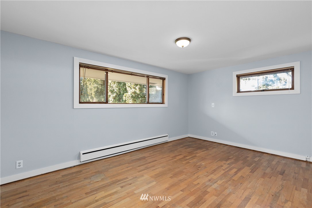645 240th Street Southeast Bothell, WA 98021 - Photo 16 of 25 a view of empty room with wooden floor and fan