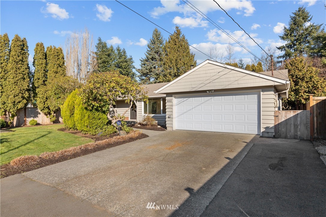 645 240th Street Southeast Bothell, WA 98021 - Photo 2 of 25 a view of a house with a yard and garage