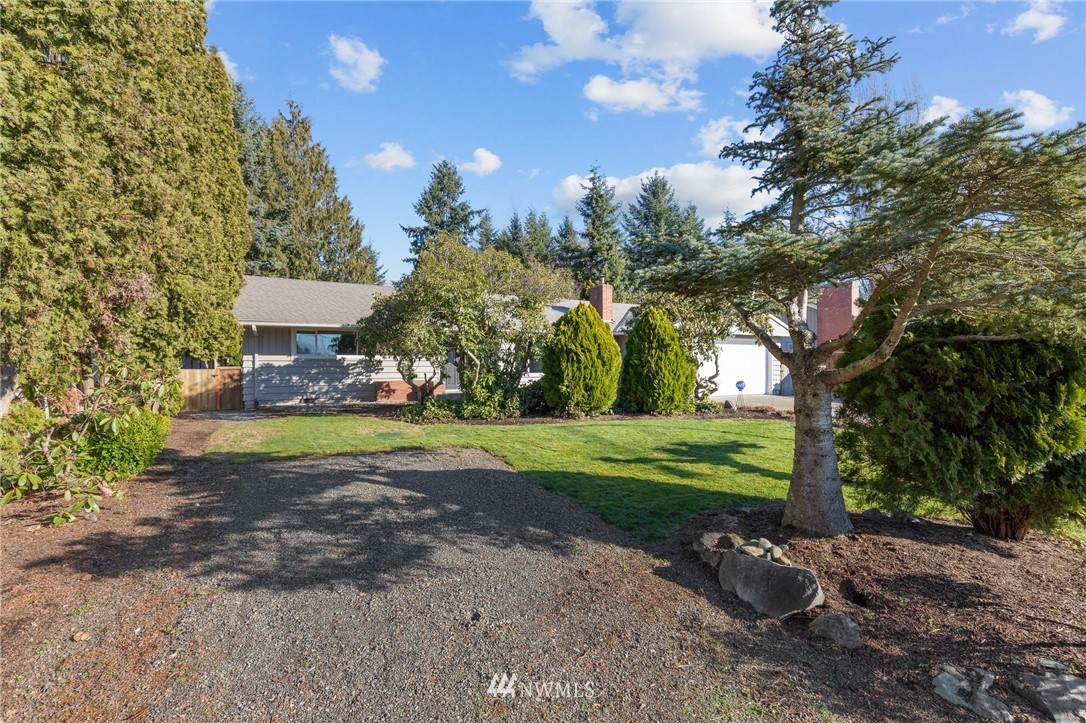 645 240th Street Southeast Bothell, WA 98021 - Photo 3 of 25 a view of a house with a yard and garden