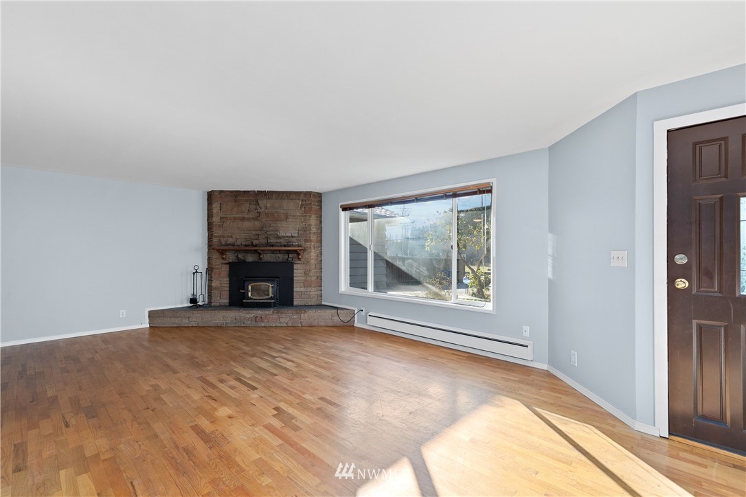 645 240th Street Southeast Bothell, WA 98021 - Photo 5 of 25 a view of empty room with a fireplace