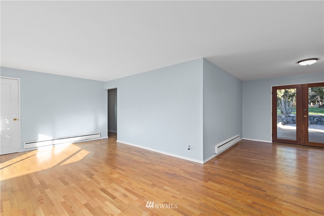 645 240th Street Southeast Bothell, WA 98021 - Photo 6 of 25 a view of an empty room with window and wooden floor