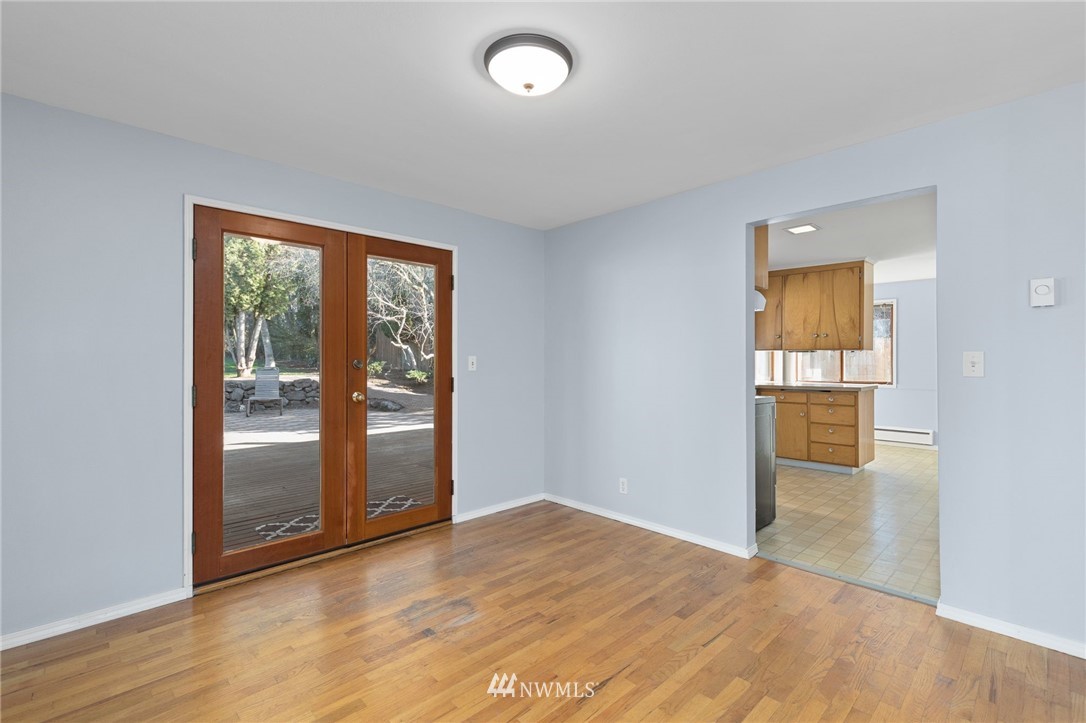 645 240th Street Southeast Bothell, WA 98021 - Photo 7 of 25 an empty room with wooden floor and a window