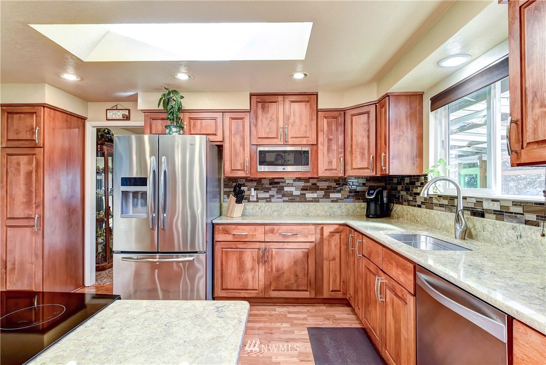 14221 Seattle Hill Road Snohomish, WA 98296 - Photo 10 of 38 a kitchen with stainless steel appliances granite countertop a refrigerator sink and cabinets