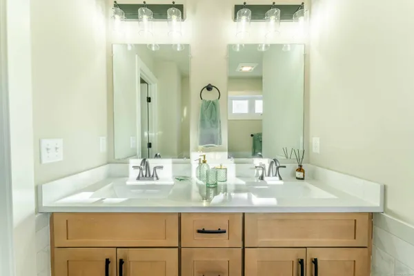 a bathroom with sinks mirror and vanity