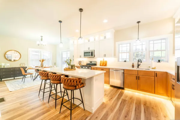 a large kitchen with a table and chairs