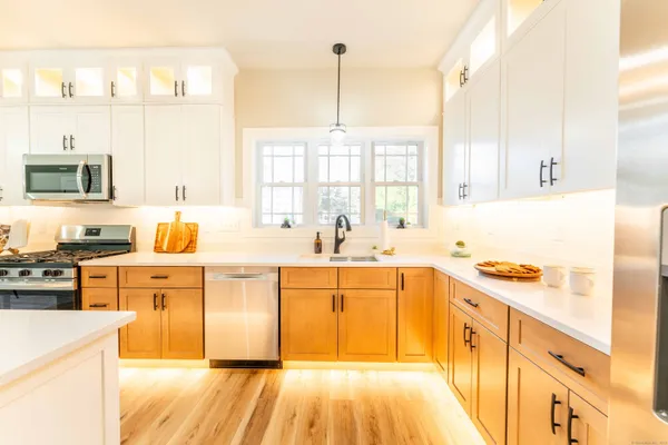 a kitchen with stainless steel appliances granite countertop a sink stove and refrigerator
