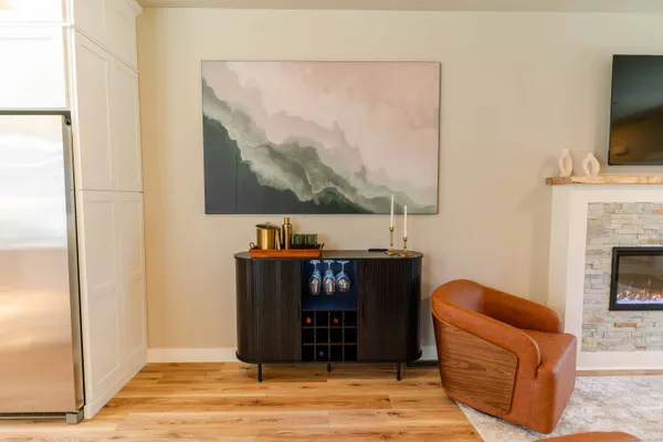 a living room with furniture a flat screen tv and a fireplace