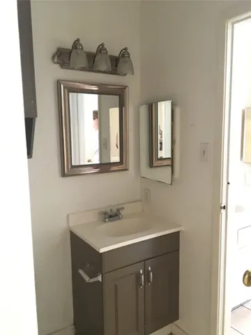 a front view of a house with a garden and yard