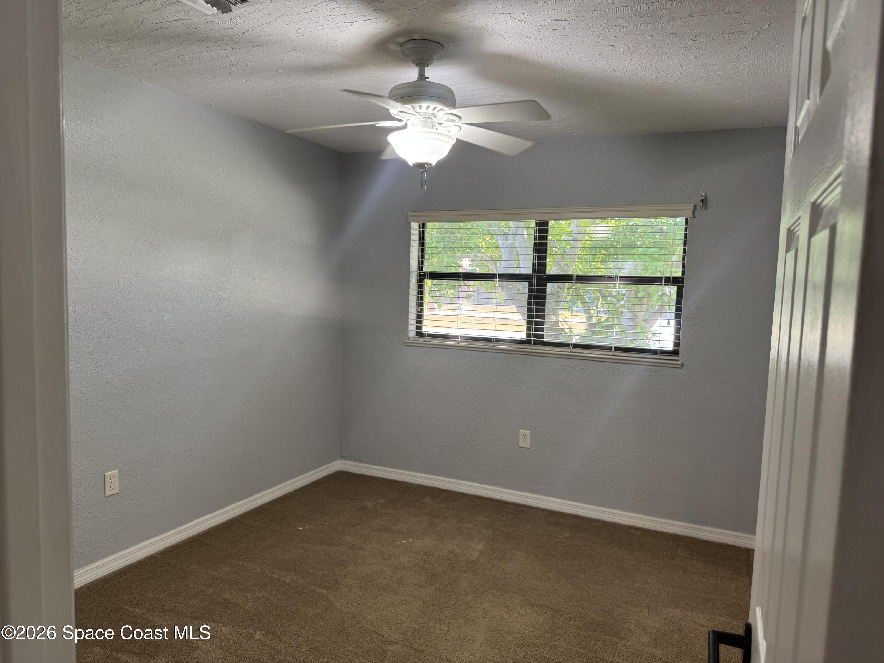 2135 South River Road Melbourne Beach, FL 32951 - Photo 6 of 14 an empty room with a window