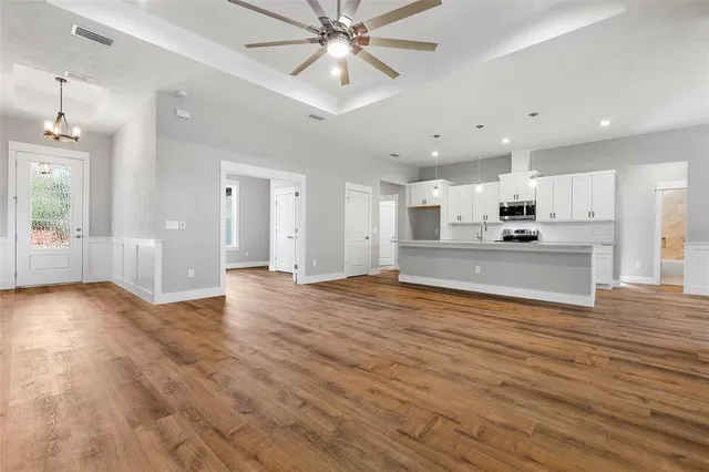 a view of a kitchen with a stove cabinets and wooden floor
