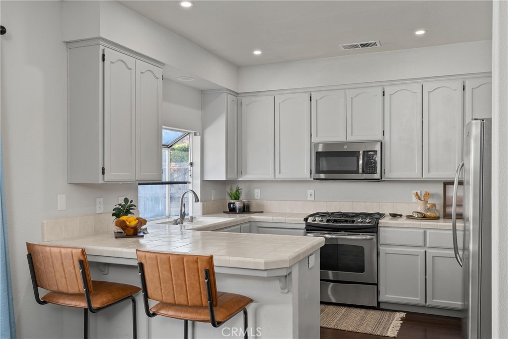 1921 Ascolano Way Chico, CA 95928 - Photo 16 of 42 a kitchen with stainless steel appliances white cabinets and a stove top oven