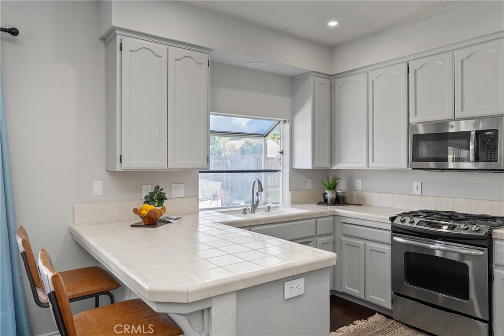 1921 Ascolano Way Chico, CA 95928 - Photo 17 of 42 a kitchen with a sink a stove and cabinets