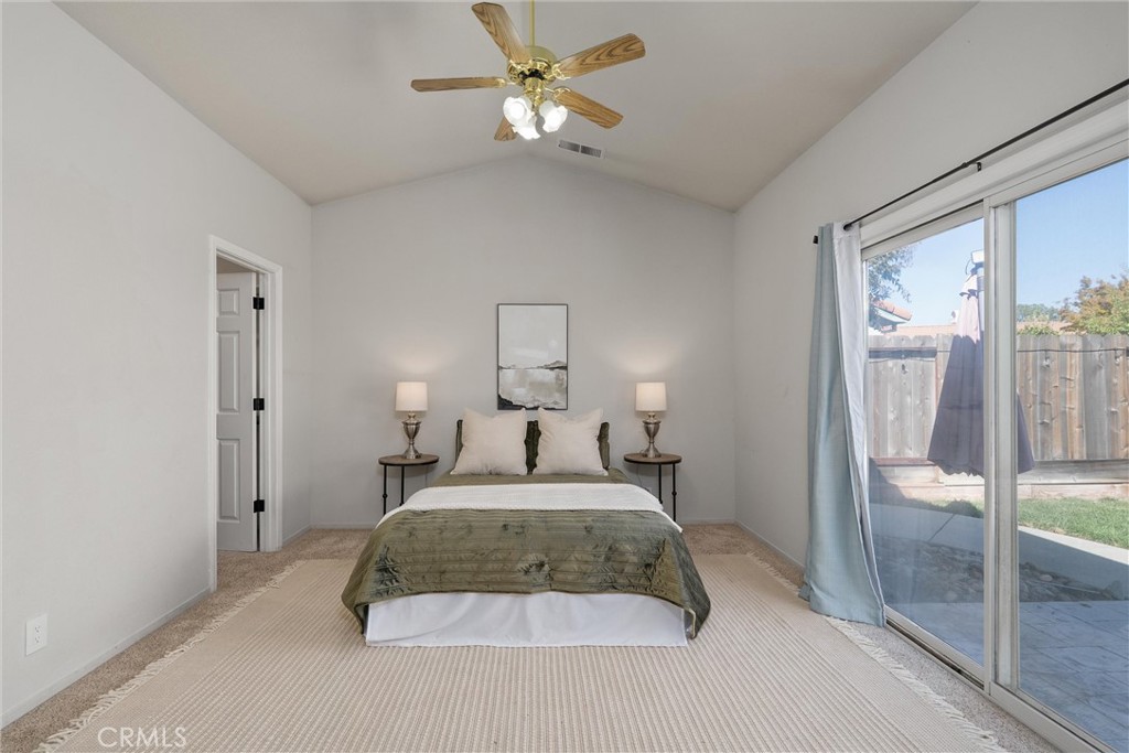 1921 Ascolano Way Chico, CA 95928 - Photo 21 of 42 a bedroom with a large bed and a chandelier