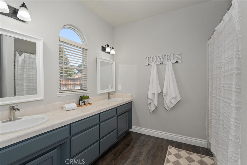 1921 Ascolano Way Chico, CA 95928 - Photo 24 of 42 a bathroom with double vanity sink a mirror and shower
