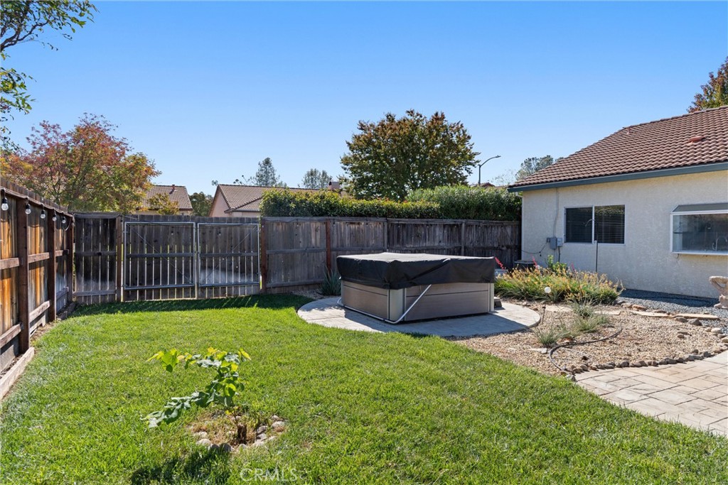 1921 Ascolano Way Chico, CA 95928 - Photo 39 of 42 a view of a backyard with table and chairs potted plants and wooden fence