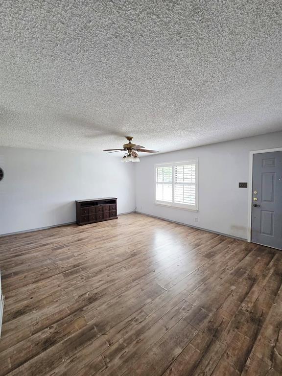722 South Church Street Pilot Point, TX 76258 - Photo 8 of 37 wooden floor in an empty room with a window