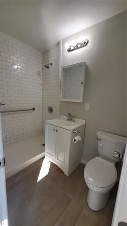 a bathroom with a toilet sink and shower