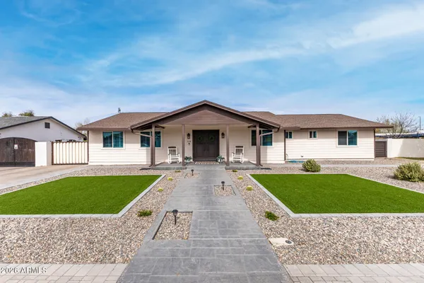 a front view of a house with yard patio and green space