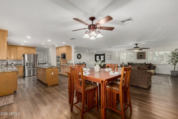 a view of a dining room with furniture and wooden floor