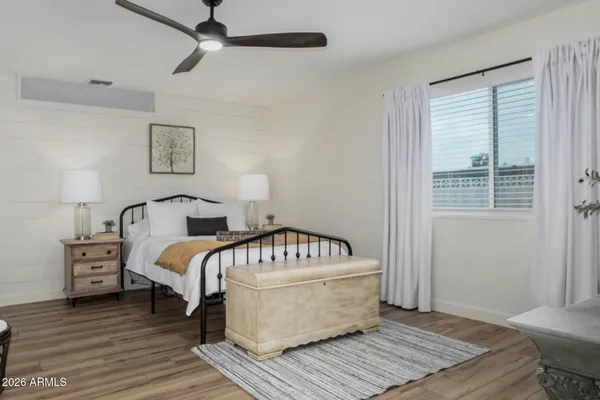 a bedroom with a bed and wooden floor