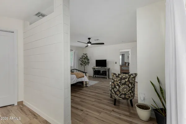 a bedroom with a bed wooden floor and a table