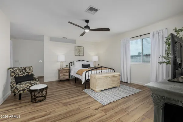 a bedroom with bed and a couch