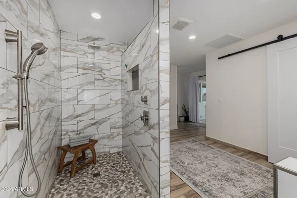a bathroom with a double vanity sink a mirror and a shower