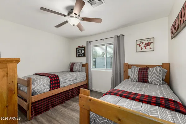 a bedroom with a large bed and a flat screen tv