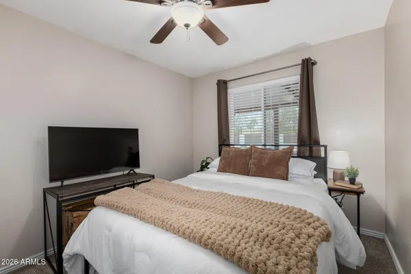 a bedroom with a bed and a chandelier