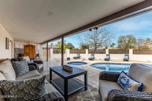 a swimming pool with outdoor seating