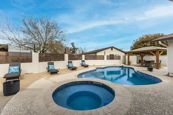 a view of a house with swimming pool and sitting area
