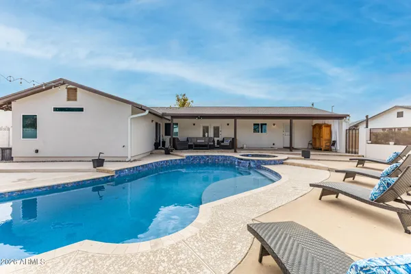 a view of a swimming pool with a patio